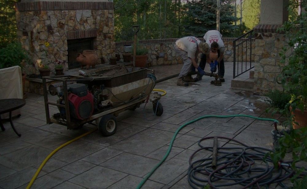 AAA Concrete Raising crew lifting a stamped patio with the portable pump