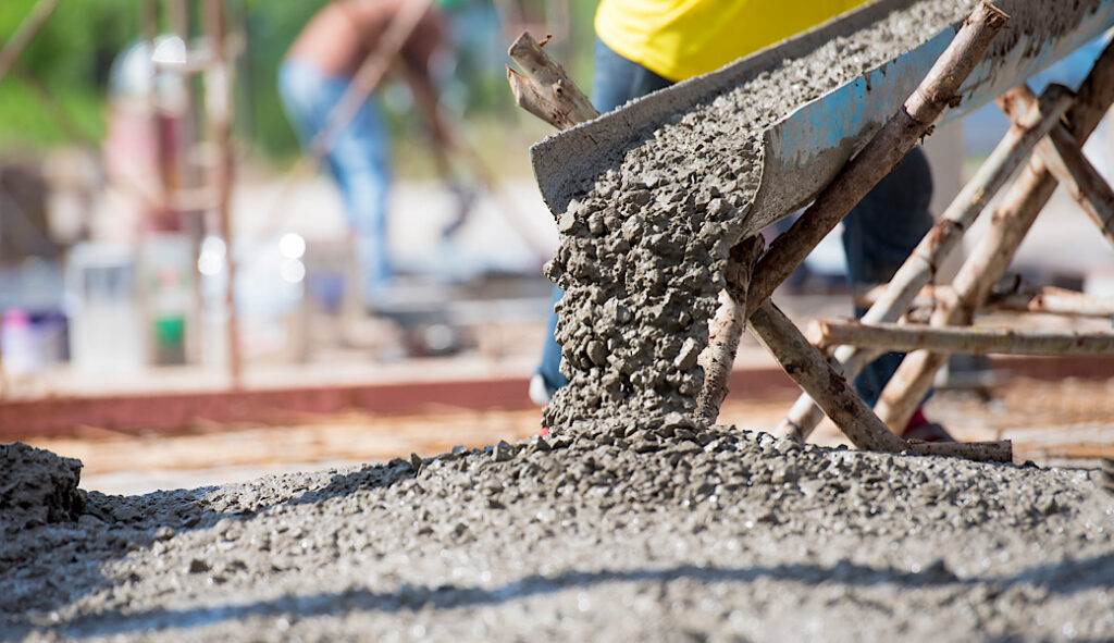 Concrete pouring during commercial concreting floors of buildings in big construction site